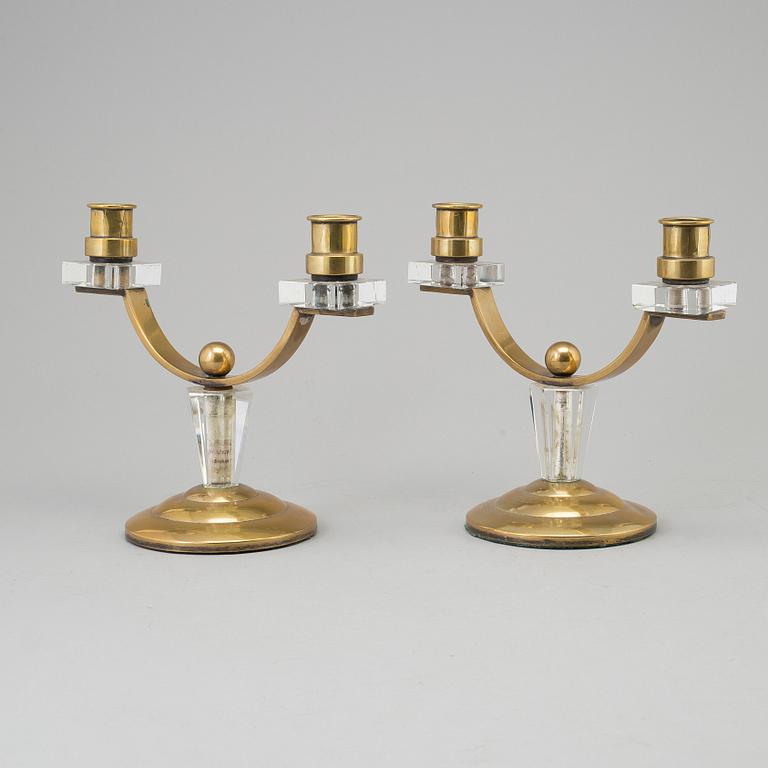 A pair of art déco brass and glass candelabra.