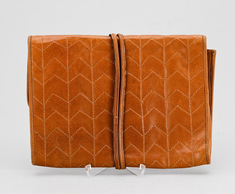 A brown leather clutch from Yves Saint Laurent.
