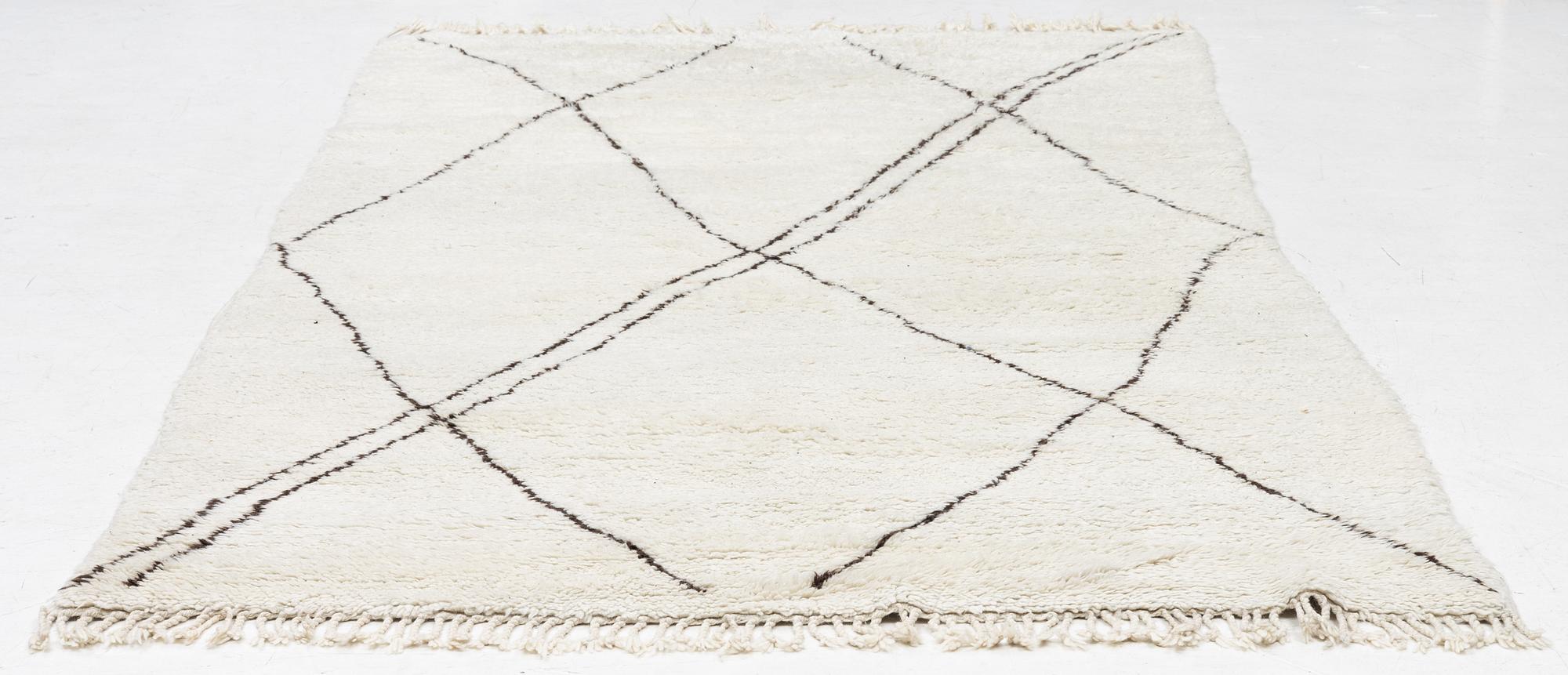 A Moroccan carpet, c. 282 x 150 cm.