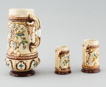 A jug and twelve beer mugs, majolica, around turn of the century 1900.