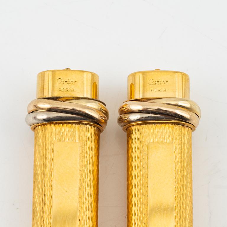 Les Must de Cartier, two gold plated 'Vendôme Trinity' pens.