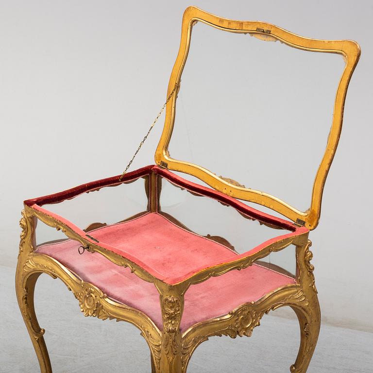 A Louis XV style display table, first half of the 20th century.