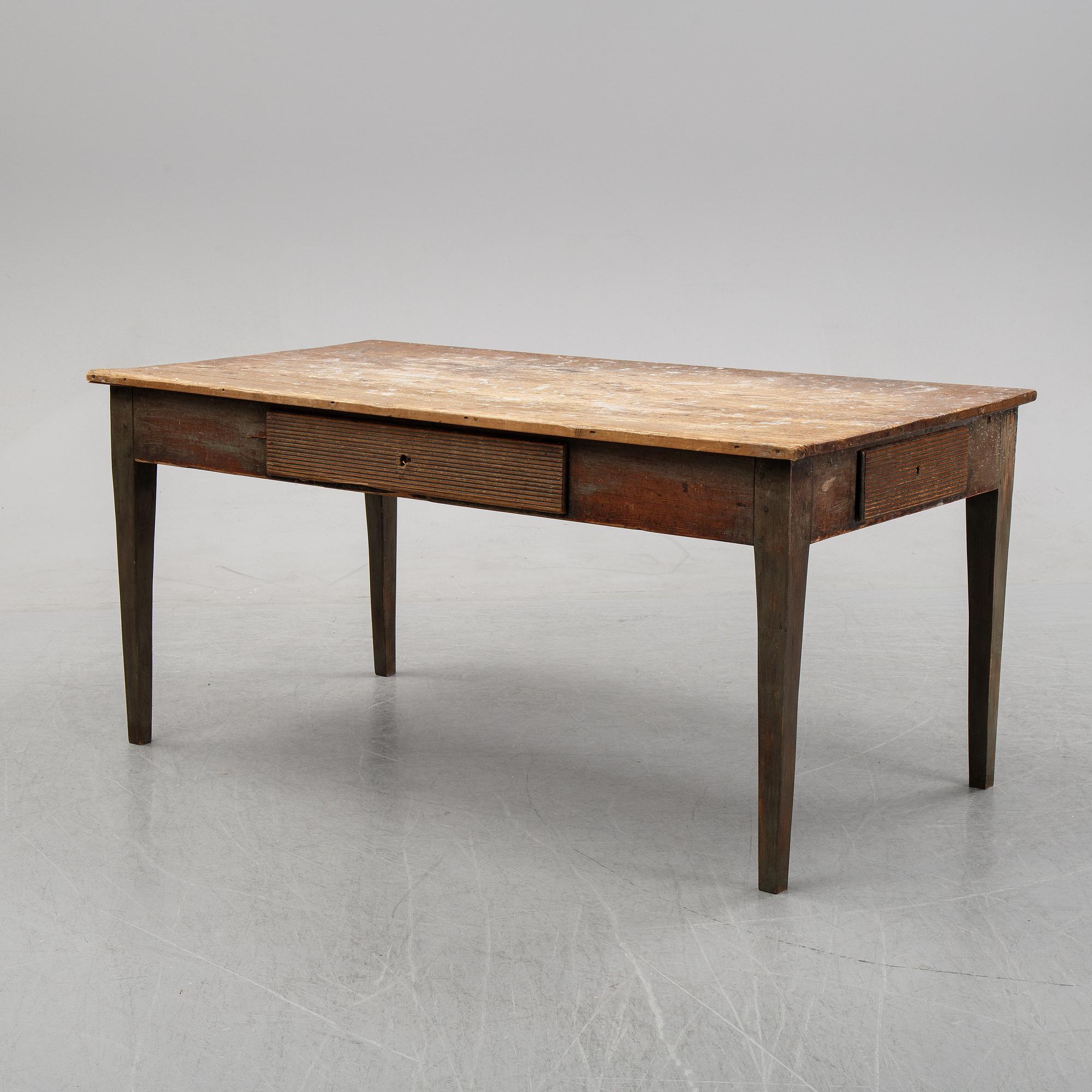 A 19th Century table with drawers.