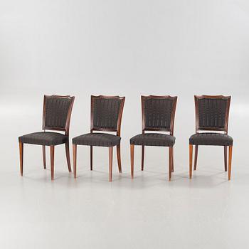 An english style dining table and eight chairs, second half of the 20th century.