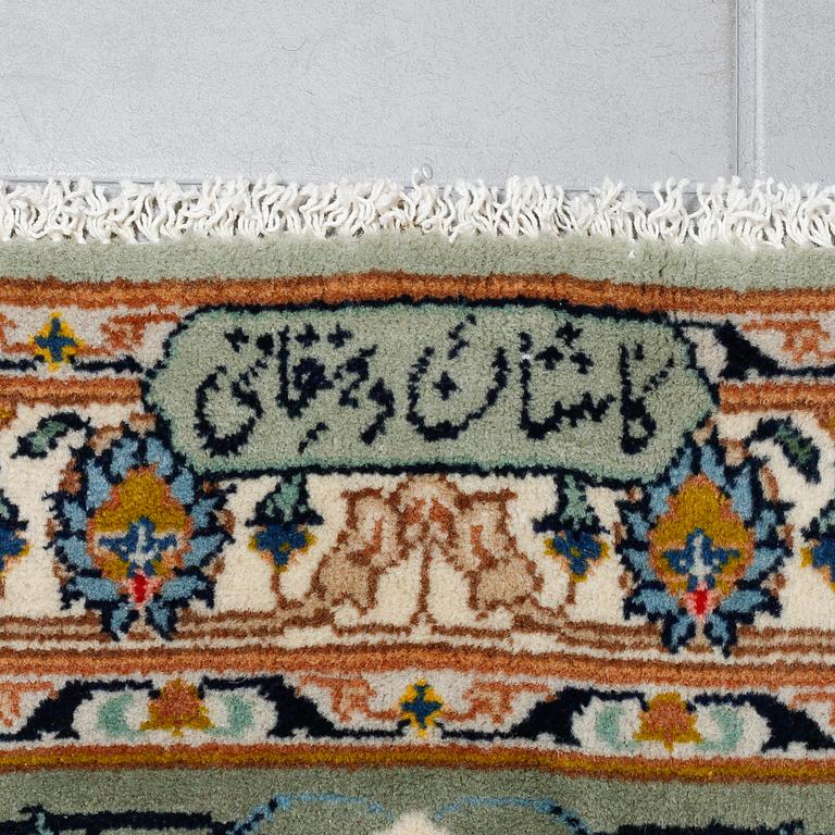 A SIGNED KESHAN RUG, 395 x 298 cm.