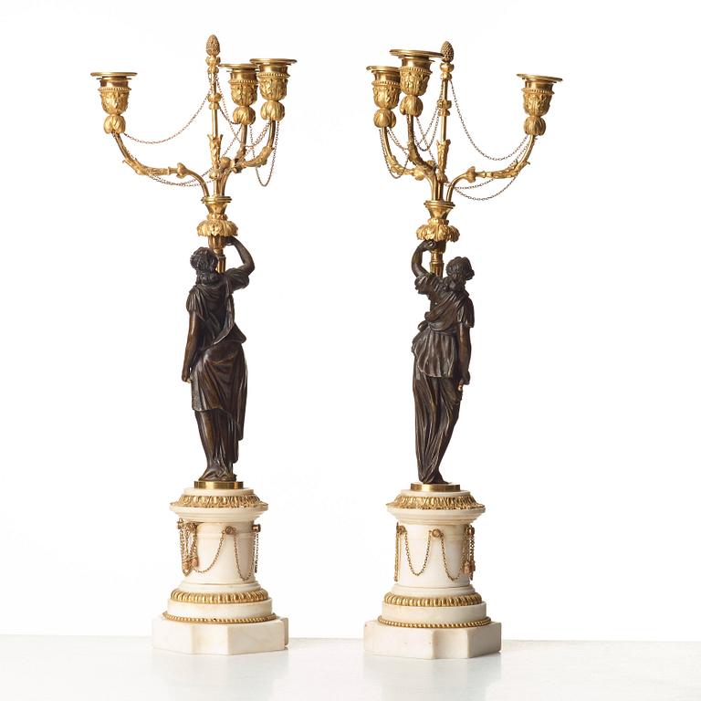 A pair of Louis XVI 18th century gilt and patinated bronze and marble three-light candelabra.