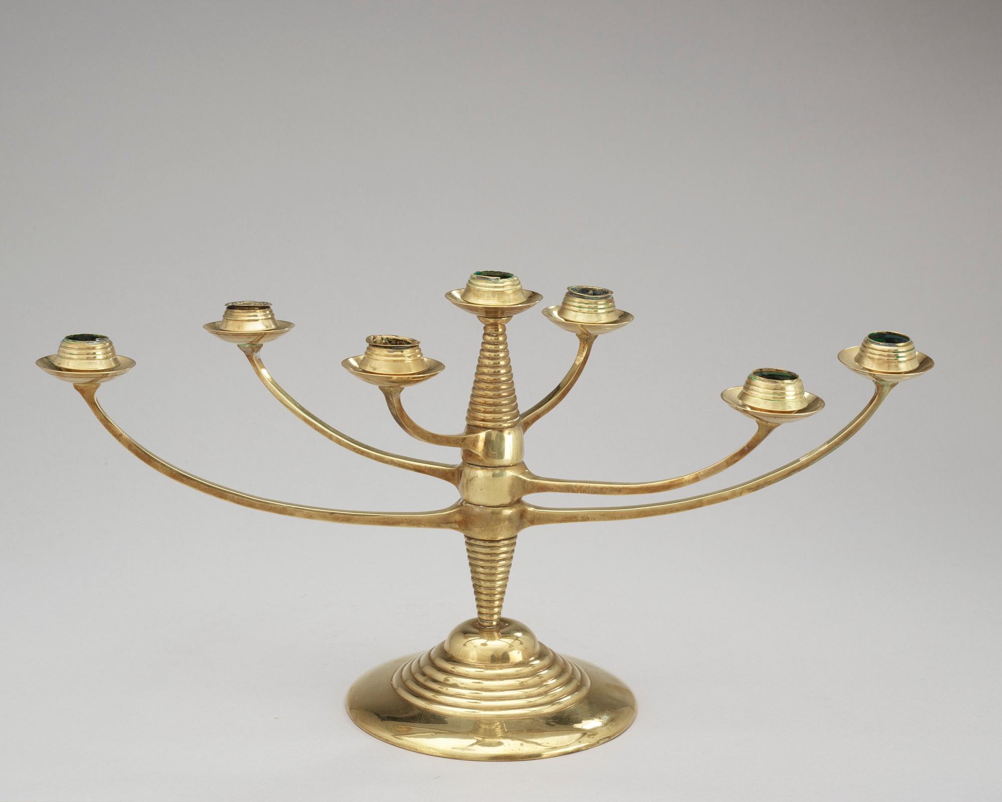 A brass candelabrum after Bruno Paul, Germany, early 20th C.