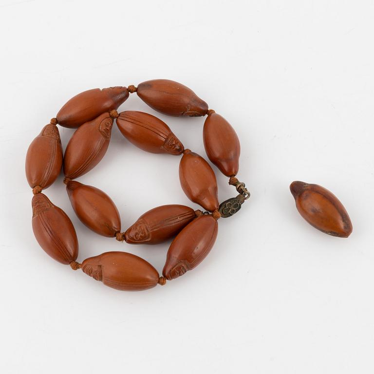 A necklace with sculptured nuts, circa 1900.