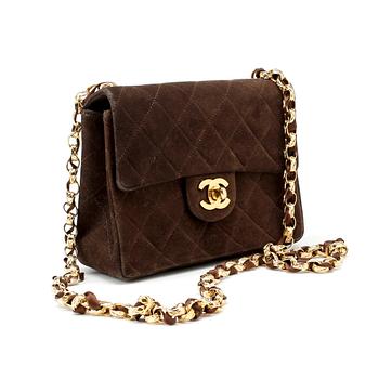 415. CHANEL, a brown suede quilted purse with shoulder strap.