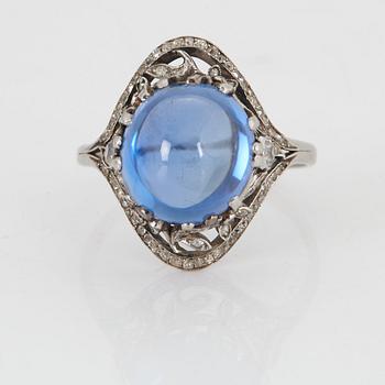 A RING set with a cabochon-cut sapphire.