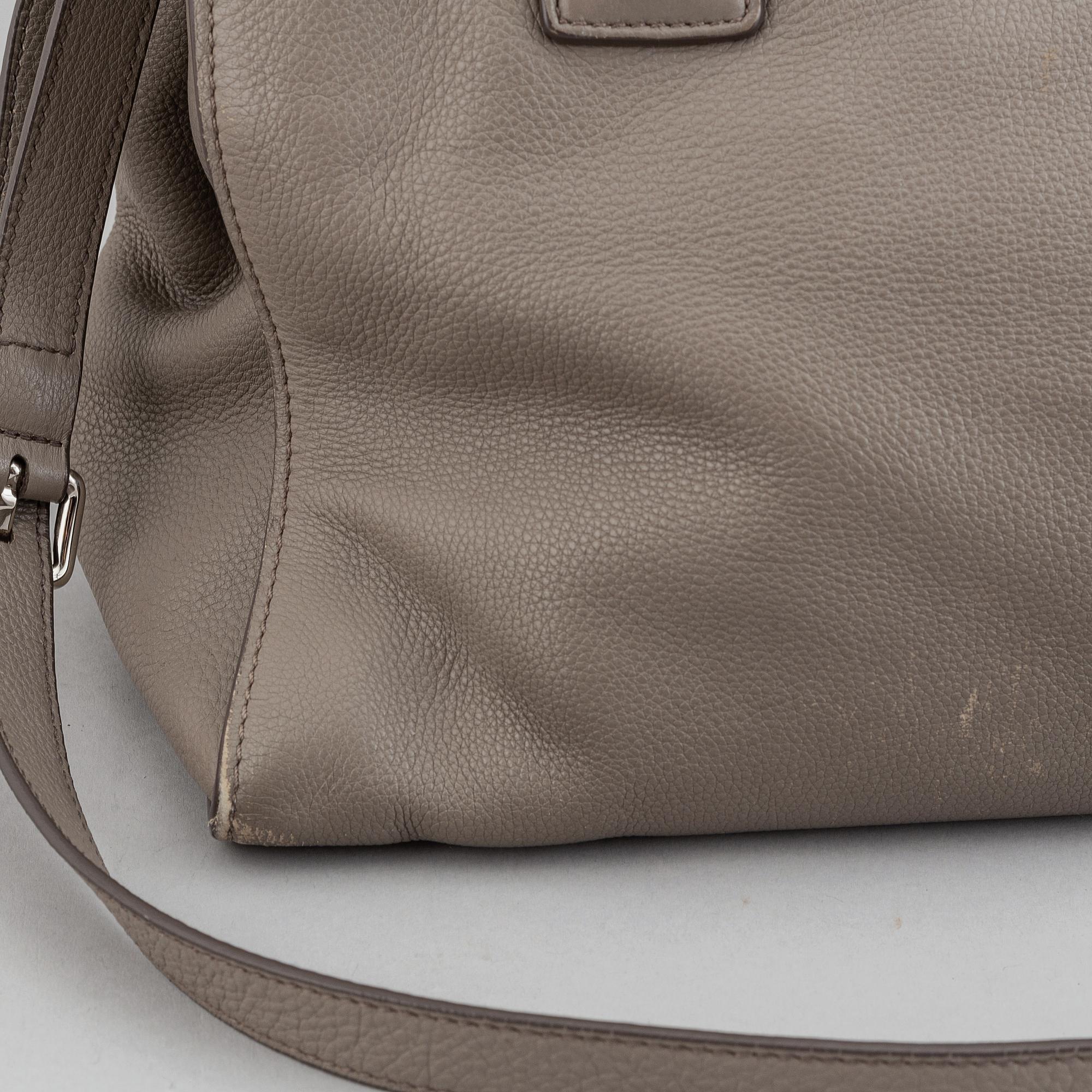 Prada, a leather handbag.
