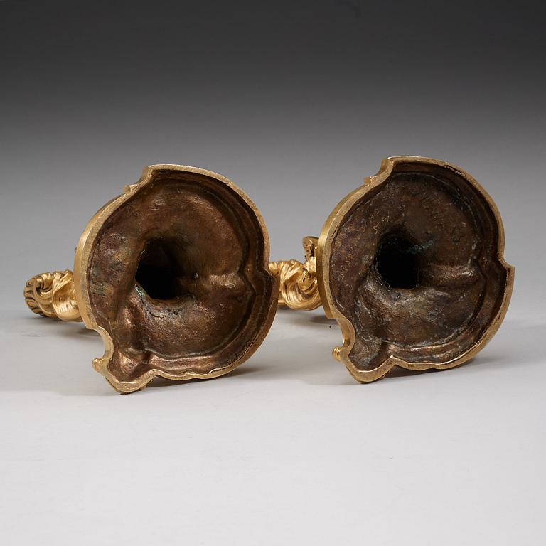 A pair of Louis XV 18th century gilt bronze candlesticks after the model by Juste-Aurèle Meissonnier.