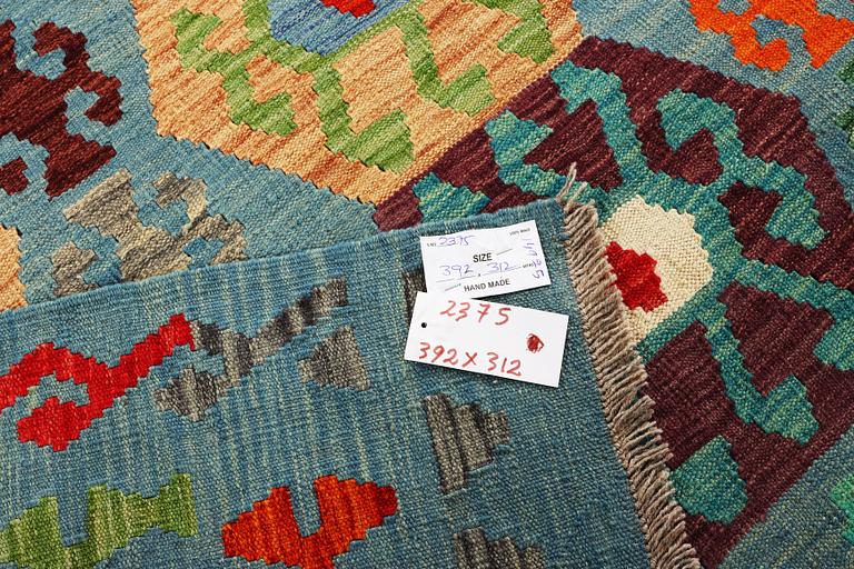 A Kilim carpet, c. 392 x 312 cm.