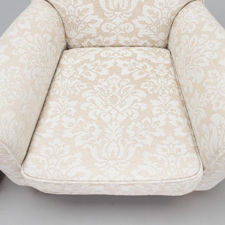 A mid-20th-century armchair and ottoman.