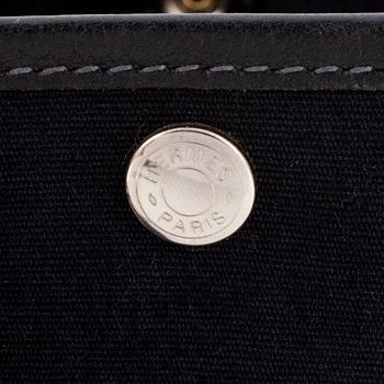 HERMÈS, a black canvas and leather bag, "Garden Party".