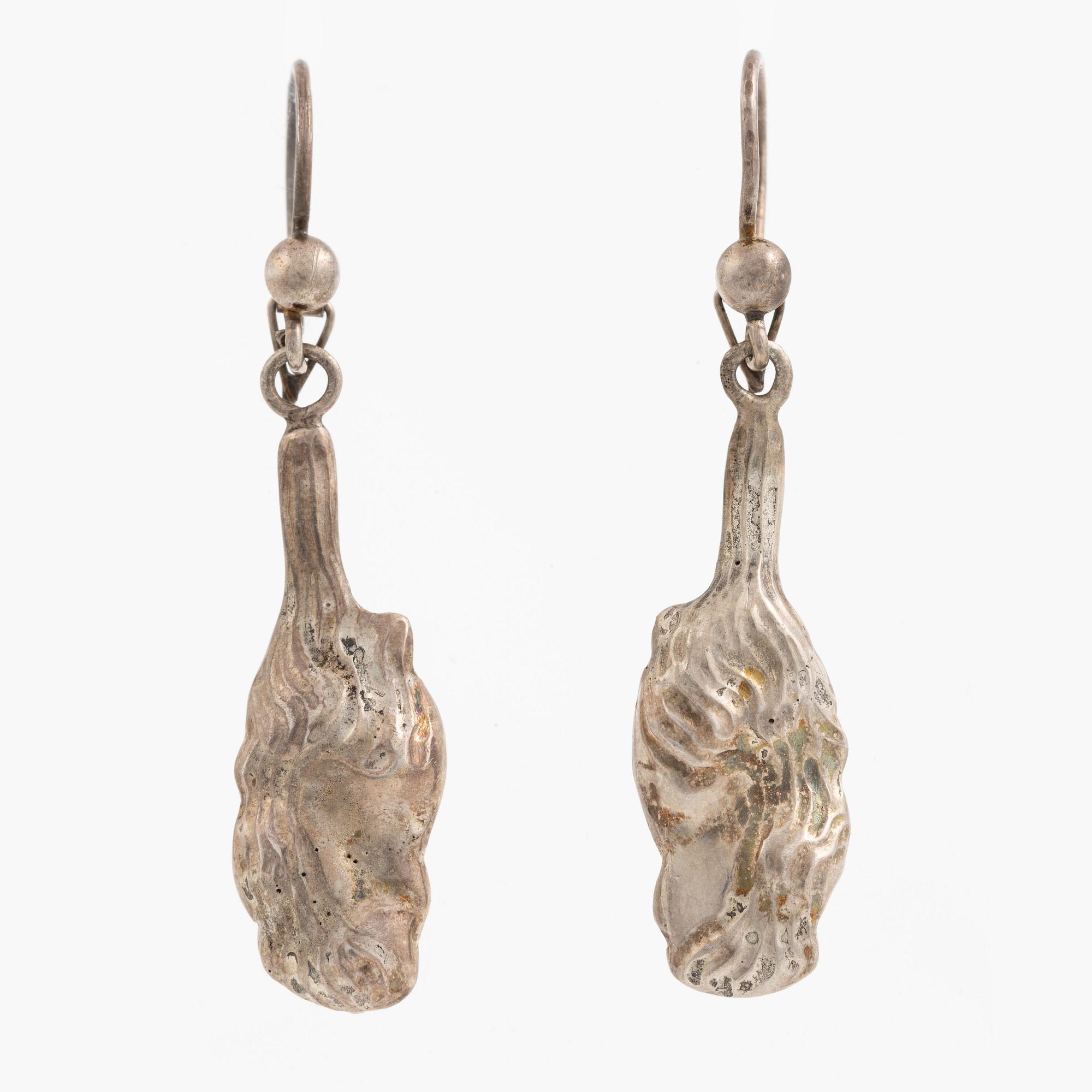 A pair of silver earrings, likely Olle Ohlsson.