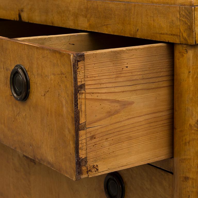 A mid 19th century chest of drawers veneered with birch.