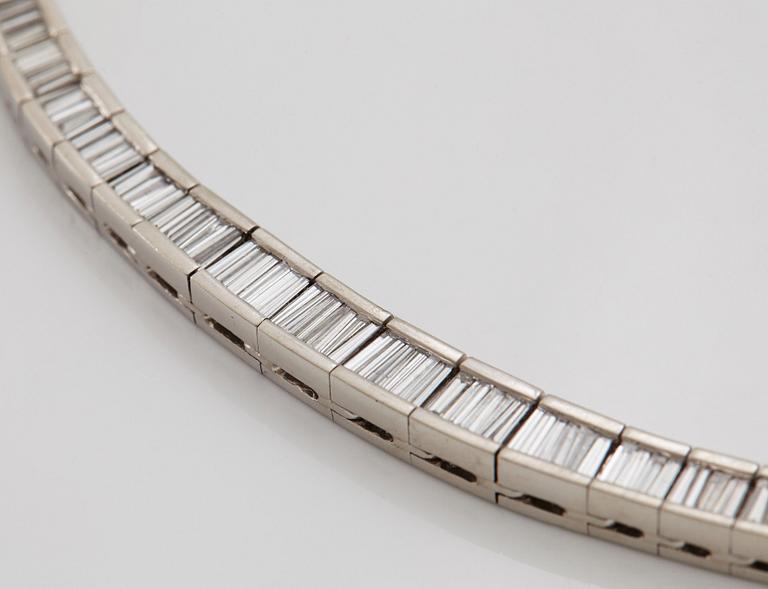 A platinum necklace set with tapered baguette-cut diamonds.