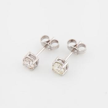 A pair of brilliant cut diamond earrings.