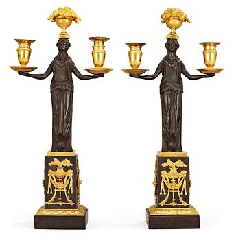 336. A pair of Empire early 19th c. two-light gilt and patinated bronze candelabra.