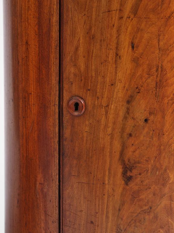 A pair of late Empire mahogany column cabinets, mid 19th Century.