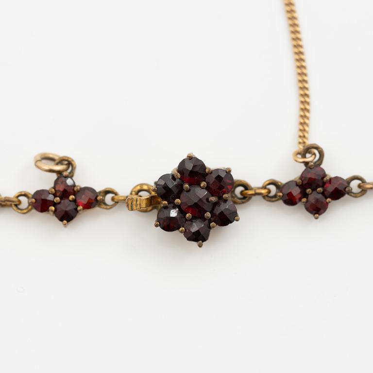 Pendant and a pair of earrings, gilt metal with garnets.