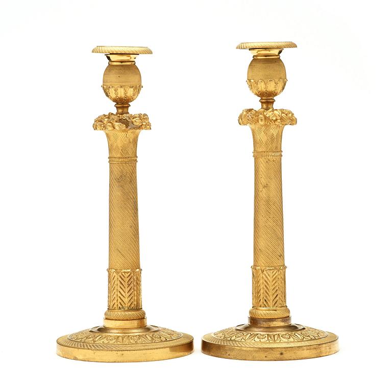 A pair of Empire early 19th century candlesticks. Signed GF.