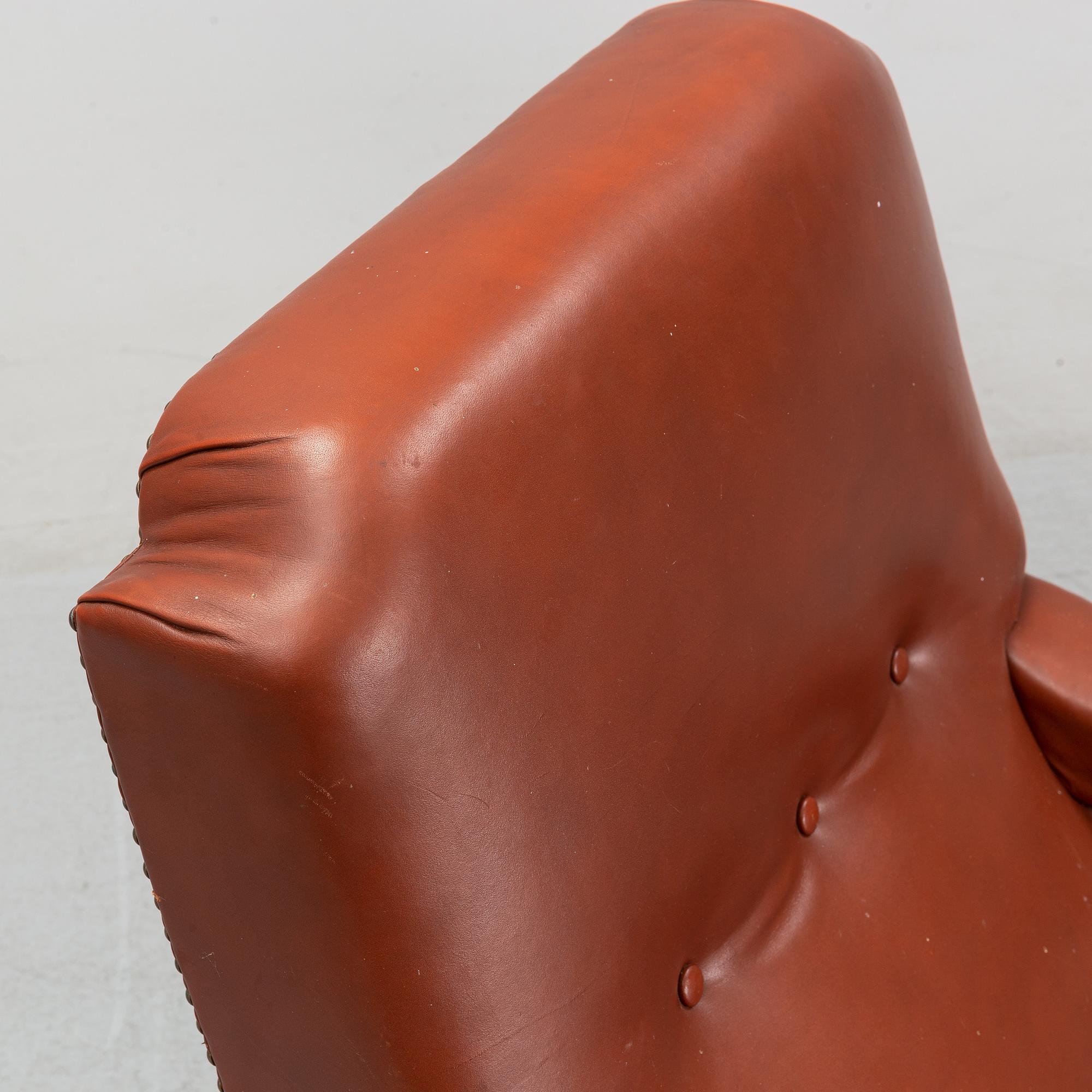 A late empire armchair with stool, mid 19th century.