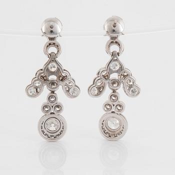 A pair of 18K white gold earrings set with old- and round brilliant-cut diamonds.