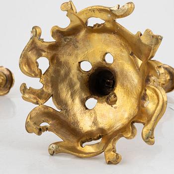 A pair of French gilt-bronze Louis XV-style candlesticks, late 19th century.