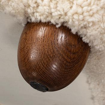 A pair of 1940's lounge chair with later sheepskin upholstery.