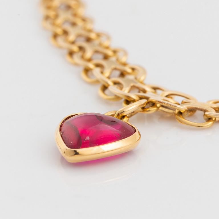 18K gold necklace with synthetic red stone heart charm.