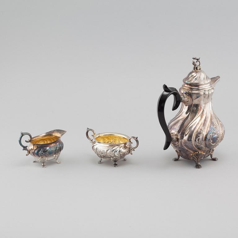 A silver rococo style coffee pot, sugar bowl and creamer from GAB and C G Hallberg in Stockholm, 1950s/60s.