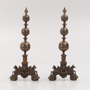 A pair of brass andirons, first half of the 20th century.