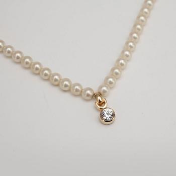 CHRISTIAN DIOR, a necklace with white decorative pearls.