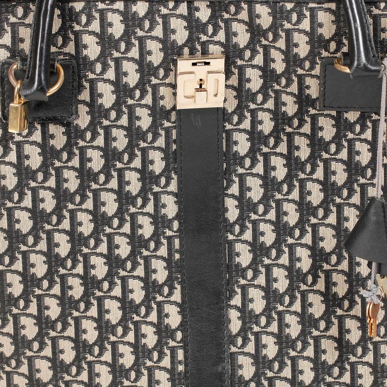 CHRISTIAN DIOR, a black monogram canvas travelling bag.