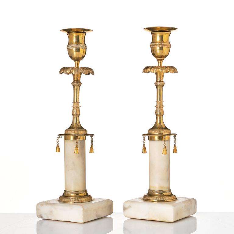 A pair of late Gustavian marble and bronze candlesticks.