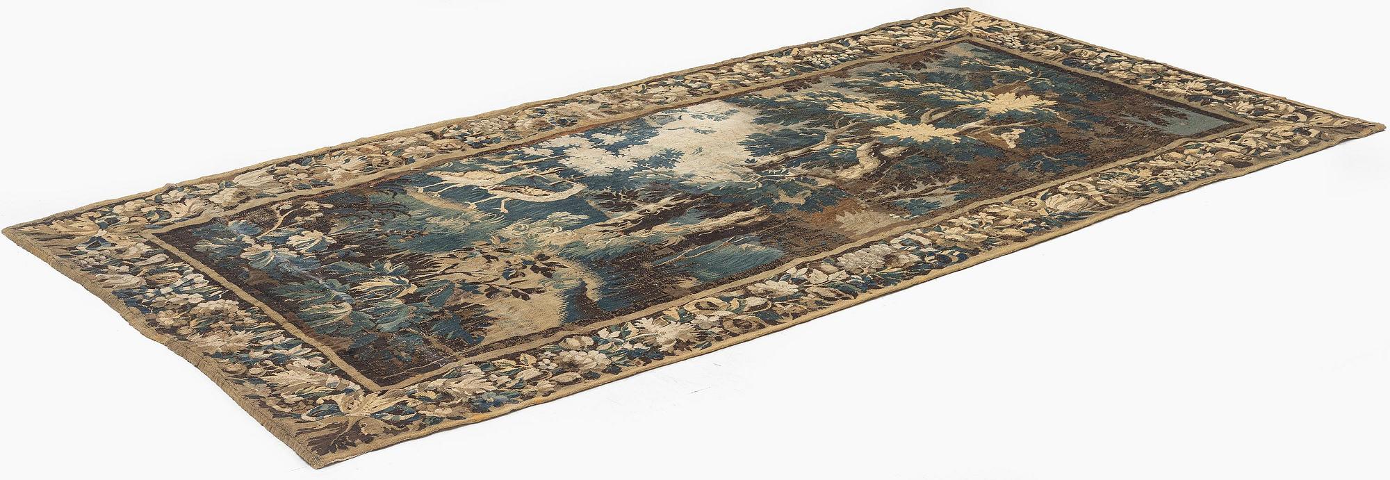 A 17th century Flemish 'verdur' entre-fenêtre tapestry, c. 268 x 130 cm.