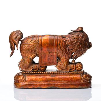 A cold gilt and lacquered copper alloy sculpture of a buddhist lion, Tibeto-Chinese/Mongolian, 18th Century.