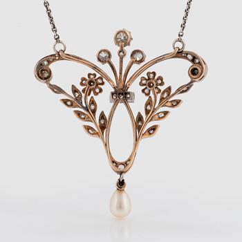 A pendant/brooch in 14K gold and platinum set with old- and rose-cut diamonds and a pearl.