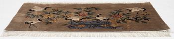 A silke figural rug, China, later part of the 20th century, ca. 92 x 170 cm.