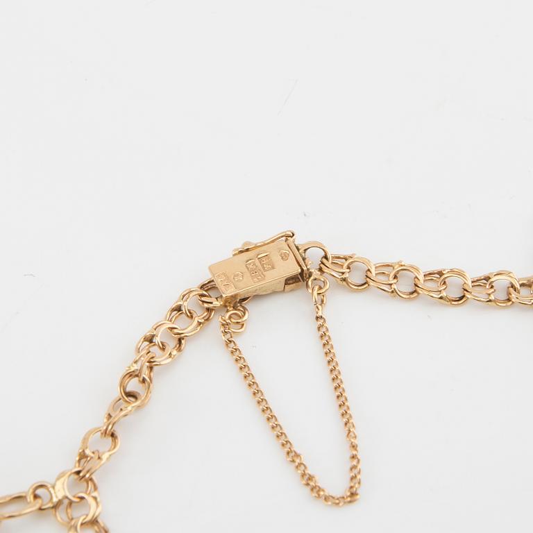 Bracelet Bismarck link 18K gold with charms.