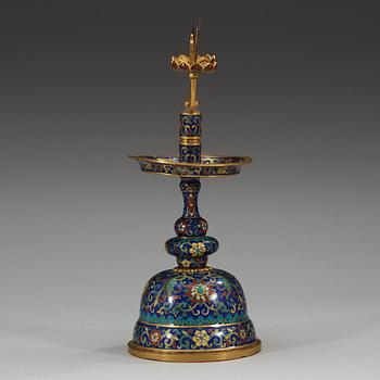 A fine Cloisonné candlestick holder with floral scrolls against a deep blue back ground, Qing dynasty, 18th Century.