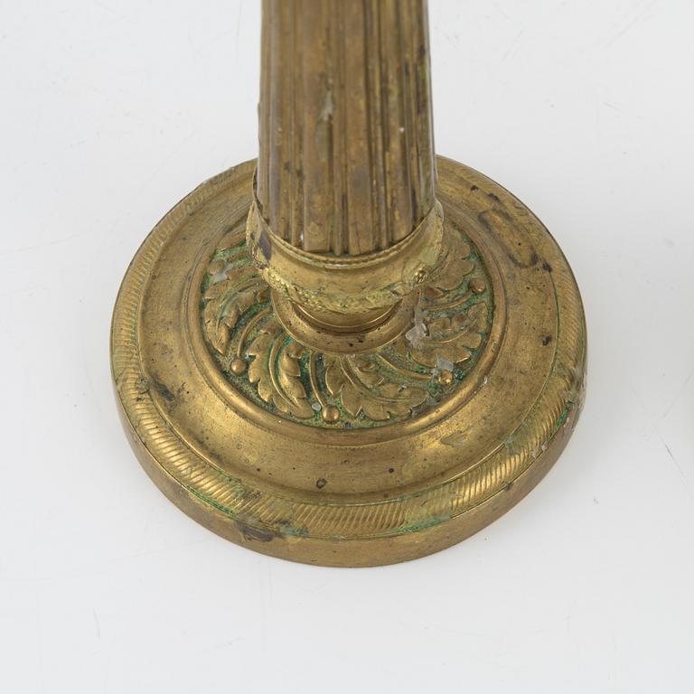 A pair of Empire bronze candlesticks, first half of the 19th Century.