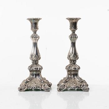 A pair of rococo-style silver candle sticks, early 20th century.