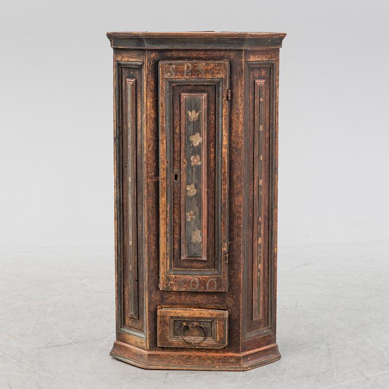A painted corner cabinet, dated 1800.