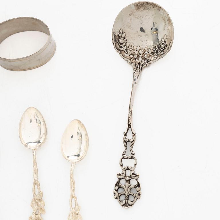A pair of beakers, two napkin rings, and 17 pieces of cutlery, silver.