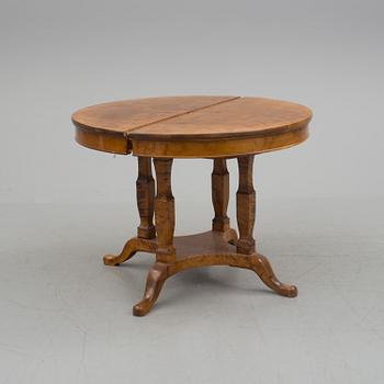 A first half of the 20th century dining table veneered with birch. With three extension leaves.