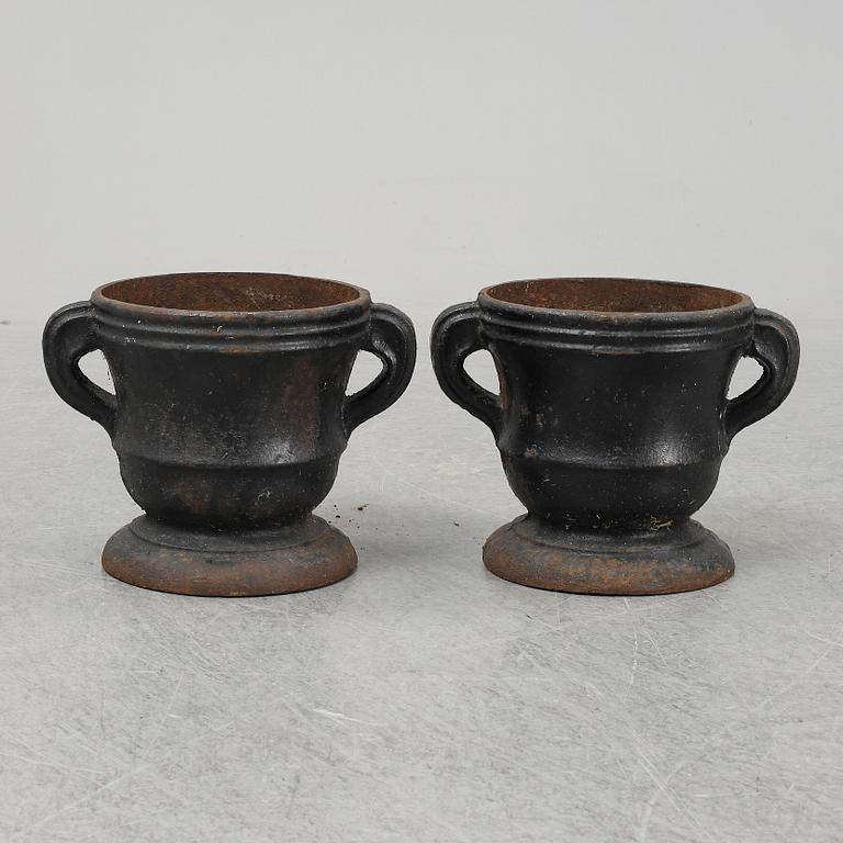 A 19th  century pair of cast iron flower pots.