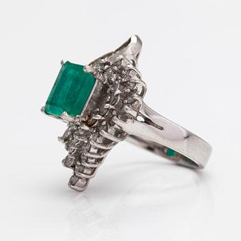 A platinum ring with a ca. 3.20 ct emerald and diamonds ca. 1.16 ct in total.